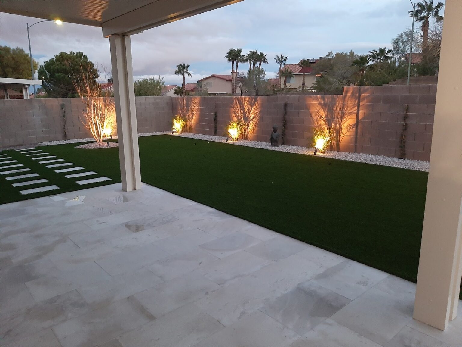Finished backyard with patio, artificial turf and lighting by FreshStart Landscaping in Las Vegas
