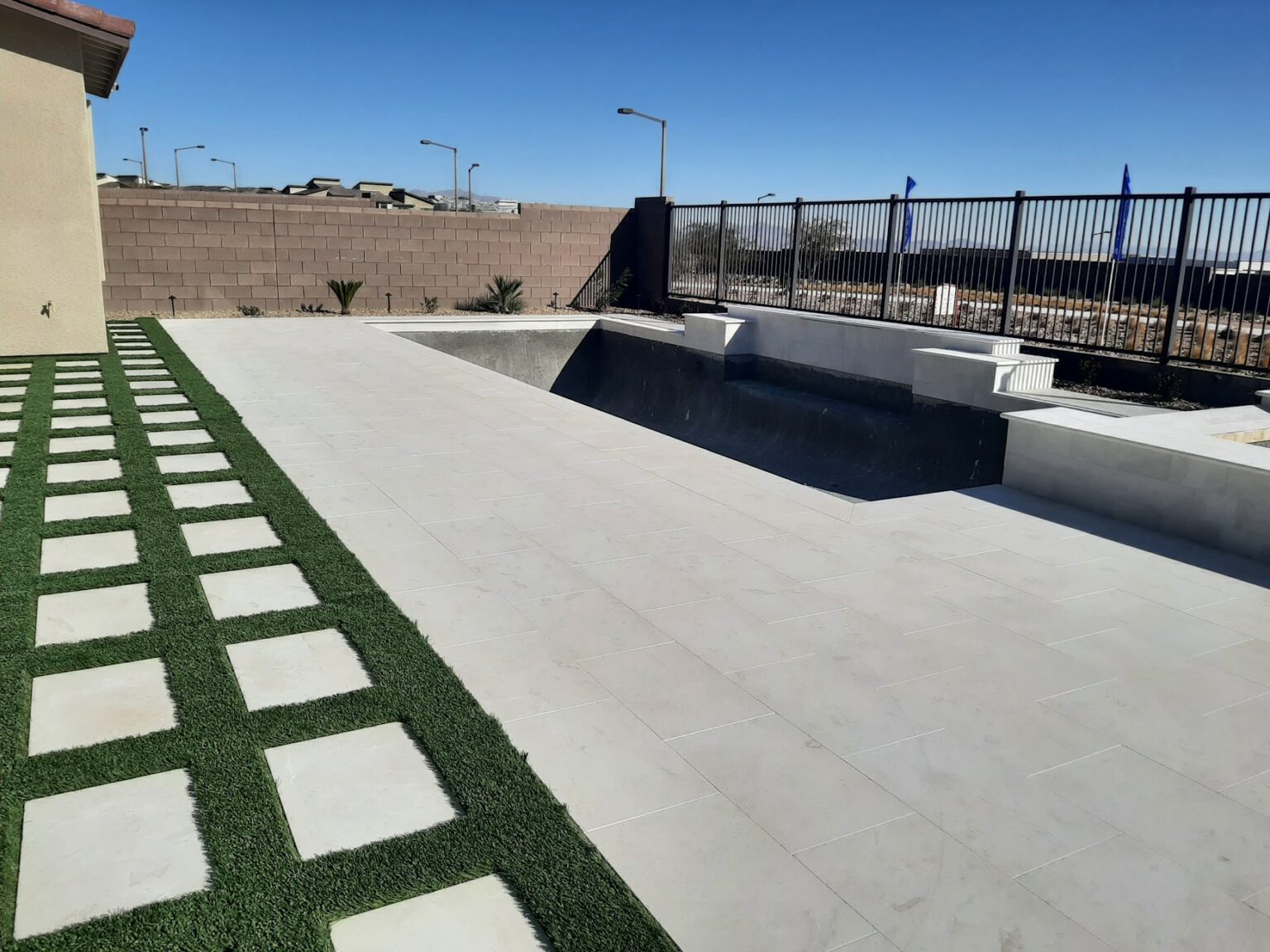 Travertine pool deck and stepping pads installed by FreshStart Landscaping in Las Vegas