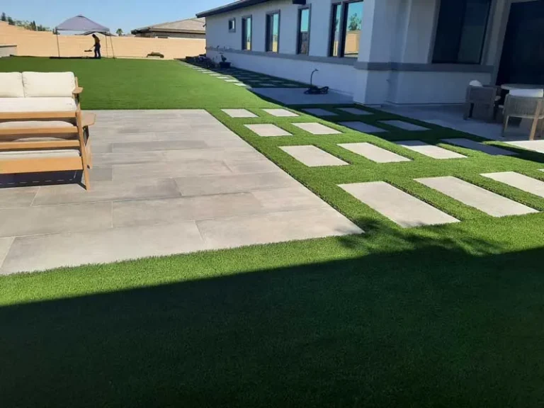 Finished new-build backyard with turf, concrete stepping pads and patio seating
