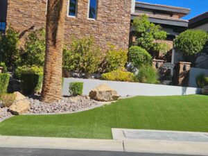 front yard landscaping with trimmed turf, desert plants and decorative rocks in Las Vegas Nevada by FreshStart Landscaping