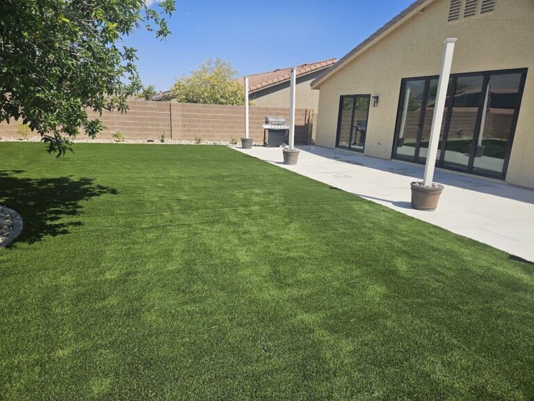 New Las Vegas backyard with fresh artificial turf and covered patio by FreshStart Landscaping